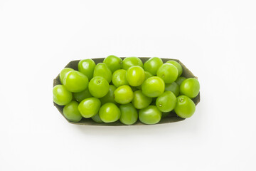 Fresh green grapes in a cardboard box on a white background. Isolated. Top view