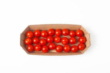 Fresh red cherry tomatoes in a cardboard box on a white background. Isolated. Top view