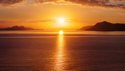Fototapeta premium Golden Sunset Reflecting On Calm Sea With Distant Mountains And Clouds Creating A Dramatic And Peaceful Atmosphere
