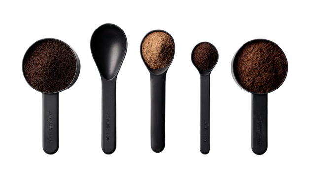 Measuring spoons filled with dark brown powder