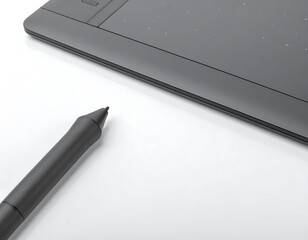 A gray graphic tablet and pen on a white surface