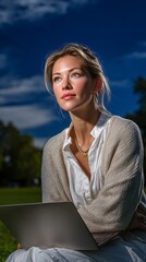 Woman in Park on a Bright Day with Laptop Contemplating Creative Ideas