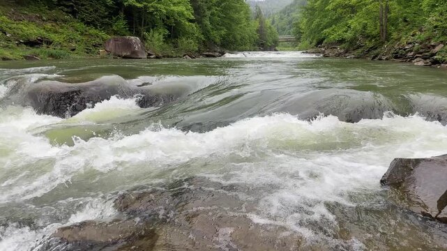 Probiy waterfall on Prut River in Carpathians in overcast day