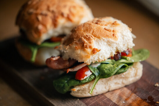 Bacon lettuce tomato "BLT" in tiger roll on wooden board
