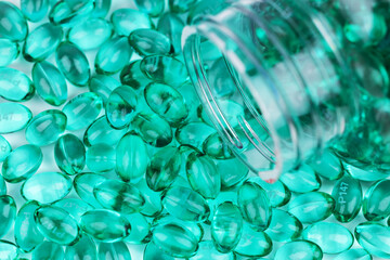 Blue vitamin capsules as background, top view