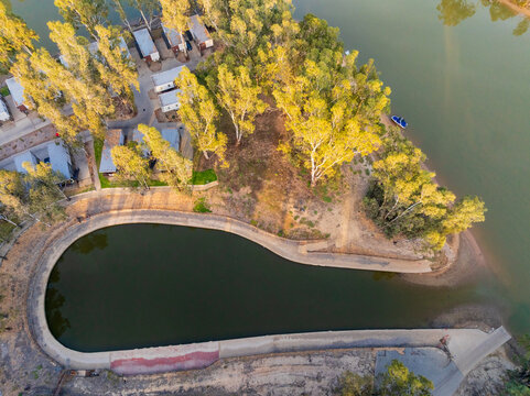Aerial view of  small riverside marina amongst gum trees in caravan park at Moama