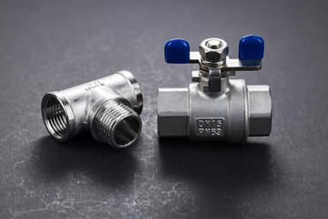 water ball valve with connecting fitting, on dark background