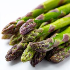 Fresh asparagus stalks are beautifully arranged, showcasing their vibrant green and purple hues. This close-up view highlights the fresh texture