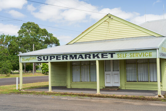 Street scene of an old small town supermarket with a wide veranda and posts over the footpath
