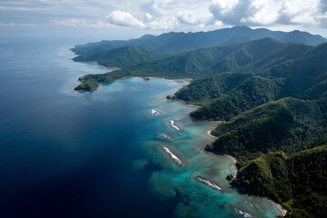 Fototapeta premium Indonesian island aerial view, lush green forests and blue ocean, 