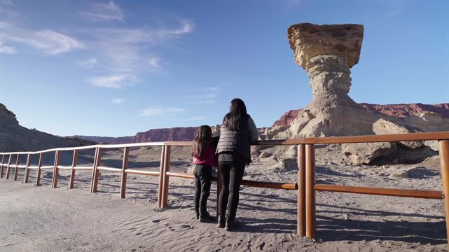 Tourist sightseeing the iconic &ldquo;El Hongo&rdquo; mushroom-shaped rock formation in the Moon Valley landscape, San Juan, Argentina.