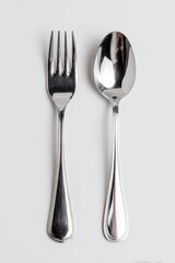 Gleaming Silverware - High-Angle Studio Shot of Fork and Spoon on White.