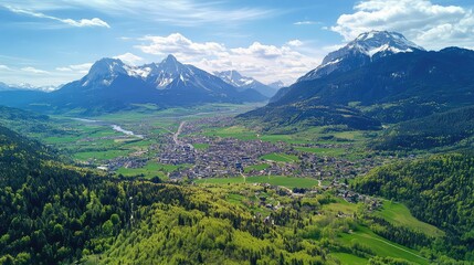 Fototapeta premium Aerial view of a european town nestled in an alpine valley