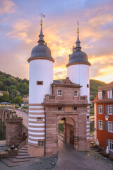 Morning light illuminates the historic City Gate and Old Bridge of Heidelberg, Germany