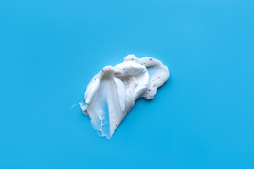 Fototapeta premium A smear of cream on a light background. Beauty concept.