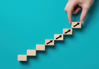 Hand Arranging Wooden Blocks with Arrows on a Blue Background