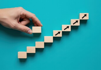 A hand arranging wooden blocks with arrows in an ascending order on a blue background