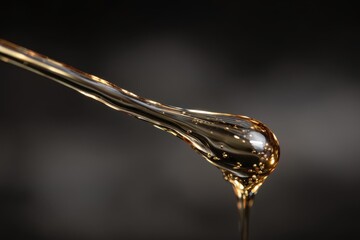 Golden Honey Drips from a Spoon, Macro Shot, Rich Amber Liquid Flowing.
