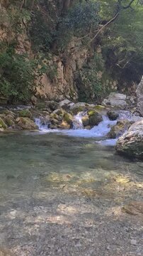 Waterfall Capelli di Venere, small mountainside cascade surrounded by vegetation, close to a ruined mill, Casaletto Spartano, Province of Salerno, Italy