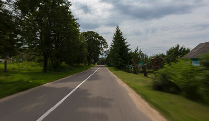 Fototapeta premium The effect of speed on the road and blur. View of the road on a summer day.