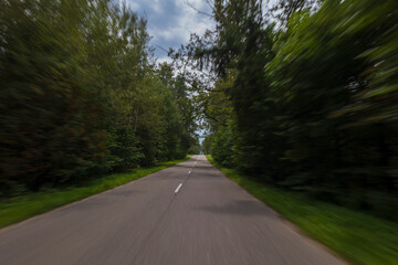 Fototapeta premium The effect of speed on the road and blur. View of the road on a summer day.