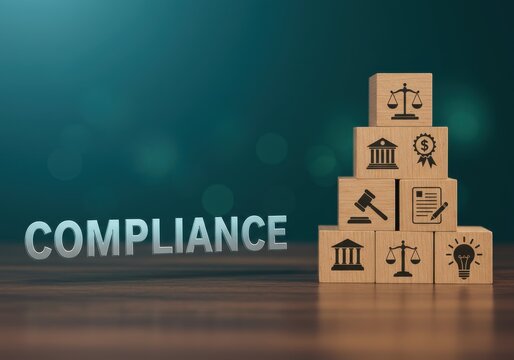Compliance icons stacked on wooden blocks on a wooden table against a green background from a straight-on viewpoint