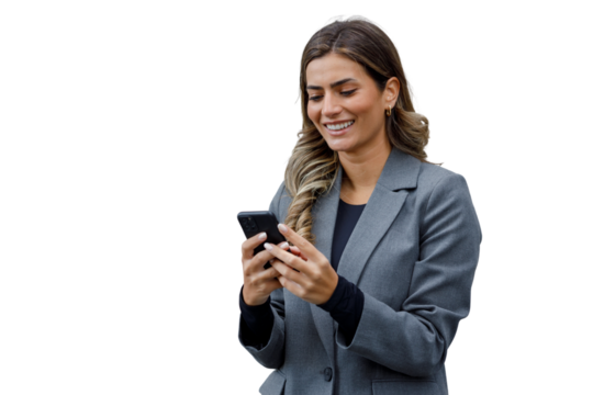Young businesswoman smiling, wearing a business suit, looking at and using a mobile phone, texting, or scrolling