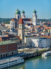 Passau, Bavaria, Germany: high view on the old town along the Danube river with the Town Hall and St Stephan cathedral; Danube cruise ships are moored