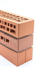 Stacked terracotta bricks against white background