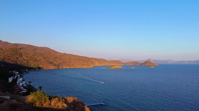 Footage capturing the coastal landscape and winding roads on the way to Knidos Ancient City Knidos Antik Kenti on the Dat&ccedil;a Peninsula, Turkey. Witness the stunning meeting point of the Aegean and Medi