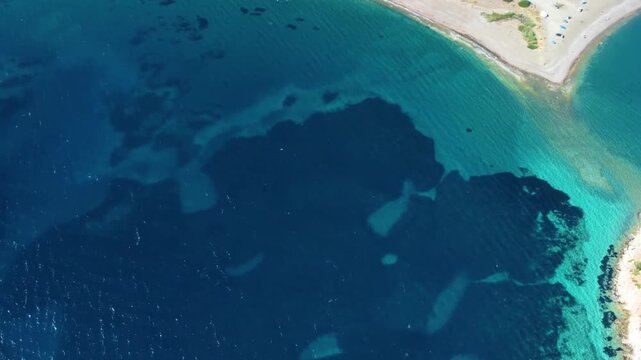 Drone footage captures the stunning turquoise waters and serene coastline of the Dat&ccedil;a Peninsula, leading towards the historical Knidos Ancient City in Turkey.