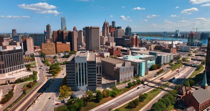Multi-lane roads leading to the downtown of the city. Approaching the midtown of Detroit, Michigan, USA at daytime. Aerial perspective.