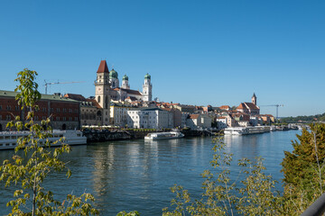 Passau, Bavaria, Germany: view over the Danube river towards Altstadt with town hall and st stephan cathedral.; cruise ships are moored.