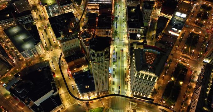 Well-illuminated streets in the downtown of a beautiful modern city. Drone footage over the scenery of Detroit, Michigan, USA.