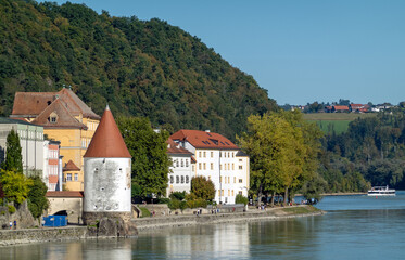Passau, Bavaria, Germany: the round tower with pointed roof of the Schaiblingsturm on the Inn quay, near the confluence with the Danube river 