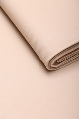 Top down close-up view of soft cashmere wool coating fabric in warm beige color perfect for autumn fashion, fall textures, and seasonal textile design. 