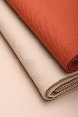 Top down close-up view of soft cashmere wool coating fabric in warm beige and terracotta color perfect for autumn fashion, fall textures, and seasonal textile design. 