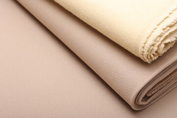 Top down close-up view of soft cashmere wool coating fabric in warm beige colors perfect for autumn fashion, fall textures, and seasonal textile design. 
