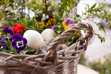 Colorful flower basket with eggs, a spring decoration for Easter celebrations outdoors