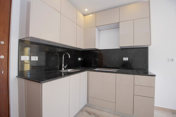 Modern kitchen in an unfurnished empty apartment