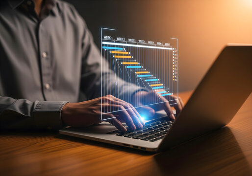 Project management and timeline planning concept. Man using laptop with Gantt chart showing weekly task tracking, representing workflow organization, scheduling, productivity and goal achievement.