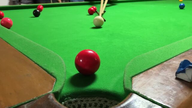 Playing a snooker shot. Indoor games. Indoor activity.