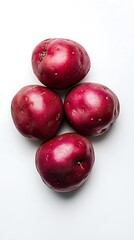 Four Fresh Red Potatoes Arranged on a Clean White Background, High Angle View