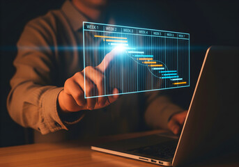 Project management and timeline planning concept. Man using laptop with Gantt chart showing weekly task tracking, representing workflow organization, scheduling, productivity and goal achievement.