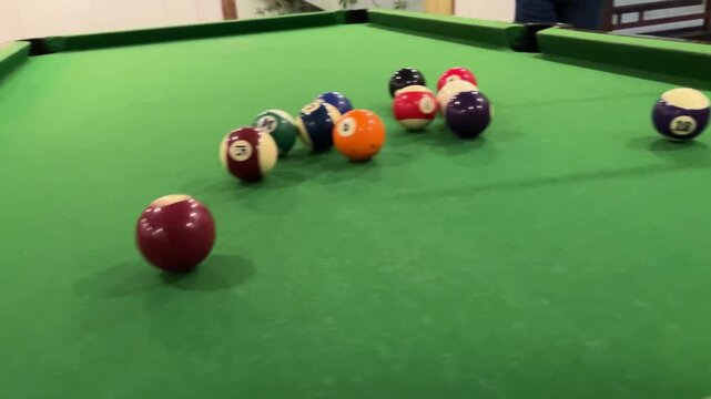 Playing a snooker shot. Indoor games. Indoor activity.