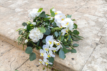 Roses orchids hydrangeas bouquet on vintage stairs
