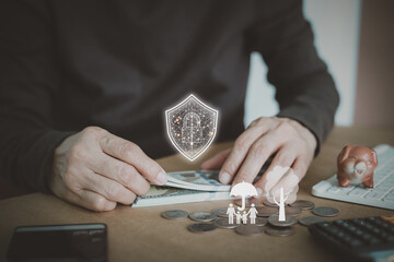 A person protects money with a digital security shield, the importance of wealth protection and family planning. life insurance, financial stability, asset management, and future planning services.