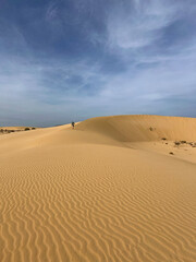 Man Walking on a Sand Dune in Corralejo Desert, Fuerteventura