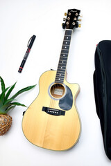 A Guitar Acoustic On A White Background