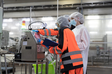 Conveyor belt, production, team of engineer factory. Group of plant engineer checking, maintaining of seafood processing conveyor belts